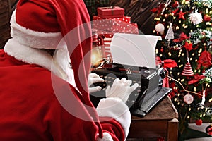 Santa Claus writing a letter on old typewriter