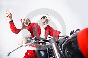 Santa Claus And Young Mrs. Claus Riding A The Motorcycle