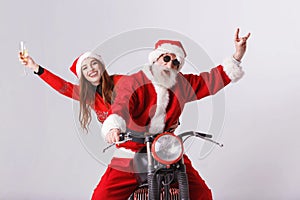 Santa Claus And Young Mrs. Claus Riding A The Motorcycle