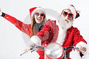 Santa Claus And Young Mrs. Claus Riding A The Motorcycle