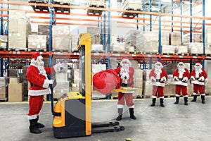 Santa clauses in line for sacks of gifts