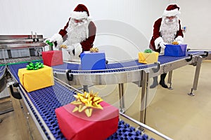 santa clauses working at present production line