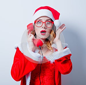 Santa Clous girl with eyeglasses and handset