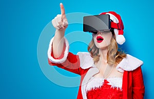 Santa Clous girl in red clothes with 3D glasses