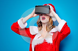 Santa Clous girl in red clothes with 3D glasses