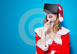 Santa Clous girl in red clothes with 3D glasses