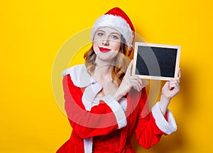 Santa Clous girl in red clothes with board