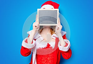 Santa Clous girl in red clothes with board