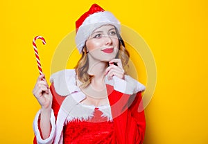 Santa Clous girl in red clothes with candy
