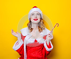 Santa Clous girl in red clothes with candy