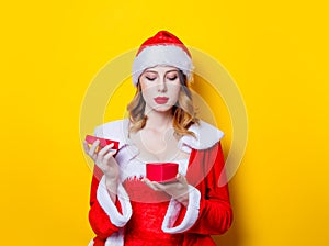 Santa Clous girl in red clothes with gift box