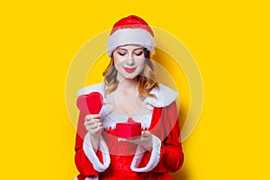 Santa Clous girl in red clothes with gift box