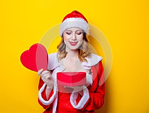 Santa Clous girl in red clothes with gift box