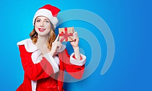 Santa Clous girl in red clothes with gift box