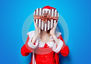 Santa Clous girl in red clothes with gift box