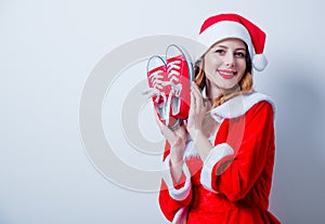 Santa Clous girl in red clothes with gumshoes