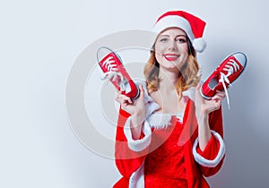 Santa Clous girl in red clothes with gumshoes