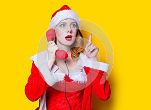 Santa Clous girl in red clothes with handset