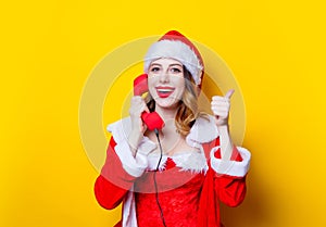 Santa Clous girl in red clothes with handset