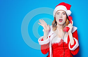 Santa Clous girl in red clothes with handset