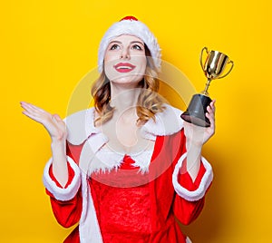 Santa Clous girl in red clothes with trophy prize