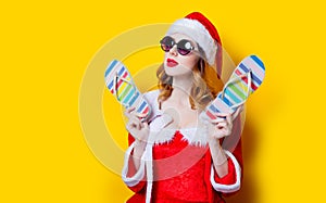 Santa Clous girl with sunglasses and flip flops