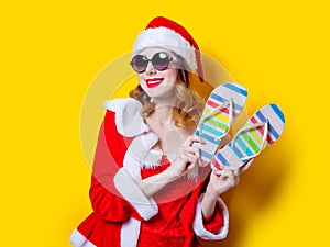 Santa Clous girl with sunglasses and flip flops