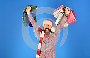 Santa with colorful packets. Man with beard and winner face