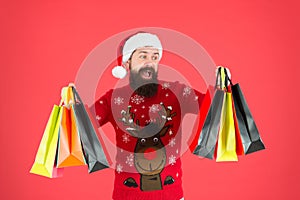 Santa is coming. Bearded hipster carry shopping bags. Packages with gifts. Happy man bought gifts. Spending more than