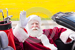 Santa in convertible with golf clubs