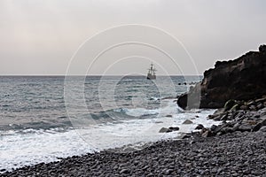Santa Cruz - Silhouette of sailing boat ship on the majestic Atlantic Ocean seen from Praia Santa Cruz, Madeira island