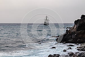 Santa Cruz - Silhouette of sailing boat ship on the majestic Atlantic Ocean seen from Praia Santa Cruz, Madeira island