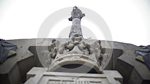 Santa Fe coat-of-arms on Columbus Monument plinth at bottom of tall column