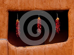 Santa Fe New Mexicp hanging ristras in adobe window