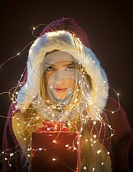 Santa girl with box in garland.