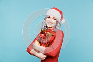 Santa girl holding golden gift with red ribbon isolated.