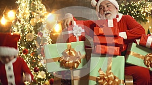 Santa grandfather with little kid boy prepare Christmas and New Year. Santa Claus brought gifts for Christmas. Santa is