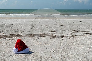 Santa hat at the beach with ocean in the background