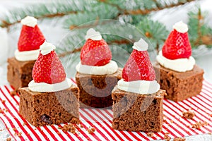 Santa hat brownie, Christmas dessert, chocolate pieces with strawberry and cream