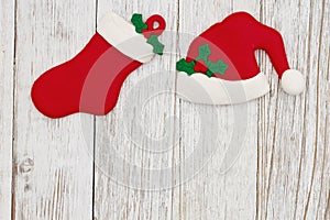 Santa hat and Christmas stocking on weathered wood holiday background