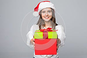 Santa hat Christmas woman holding christmas gift smiling happy and excited on grey background