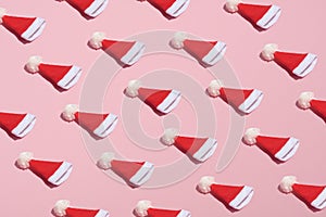 Santa hat pattern on pink background. Christmas, winter holidays, New year concept. Minimal style