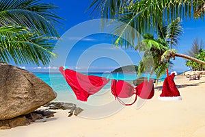 Santa hat and red bikini on the tropical beach