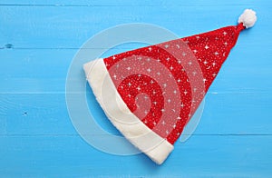 Santa hat with stars on blue wooden background