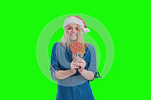 santa hat woman smilling and holding a lollipop in green screen