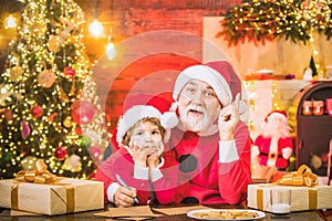 Santa helper grandson and grandfather Write Letter to Santa Claus.