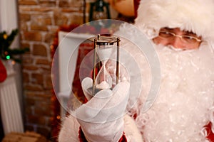 Santa holding hourglass indicating Christmas is near