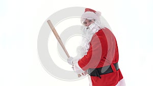 Santa holds, swings, beats baseball bat. Santa Claus is playing baseball bat on white background