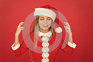 Santa little girl meditate. relax and smiling. child santa red background. its christmas. happy new year. waiting for