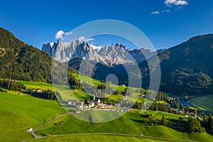 Santa Maddalena (Santa Magdalena) village with magical Dolomites mountains in background, Val di Funes valley, Trentino Alto Adige photo